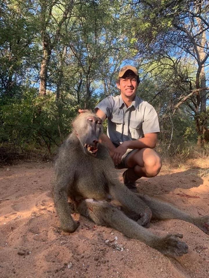 A hunter with a chacma baboon taken on management quota