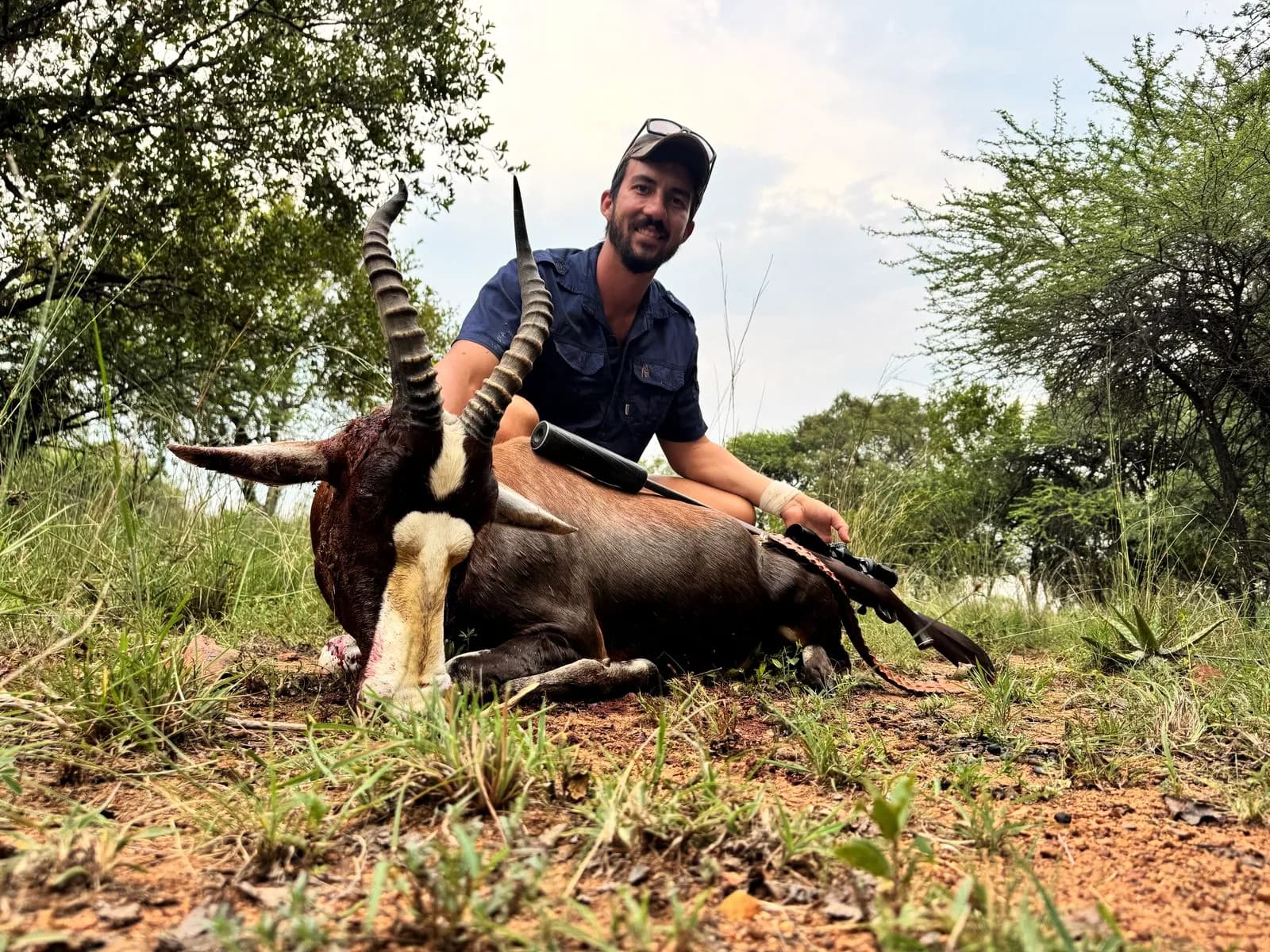 A hunter with a common blesbok ram