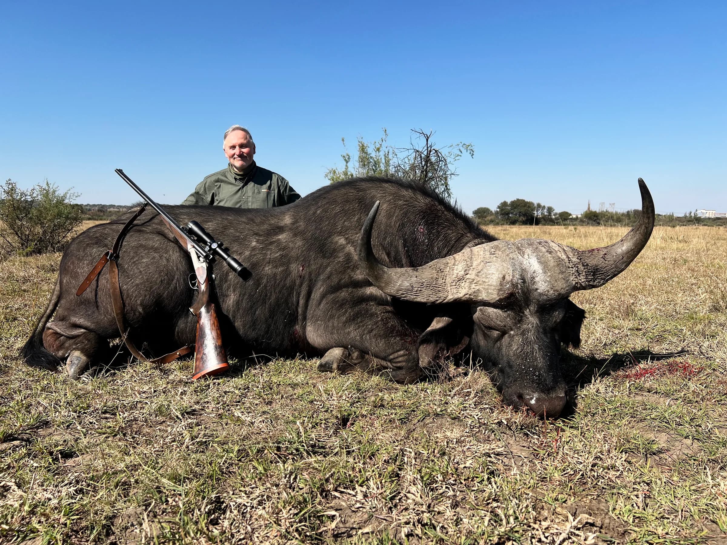 A hunter with a blue wildebeest bull