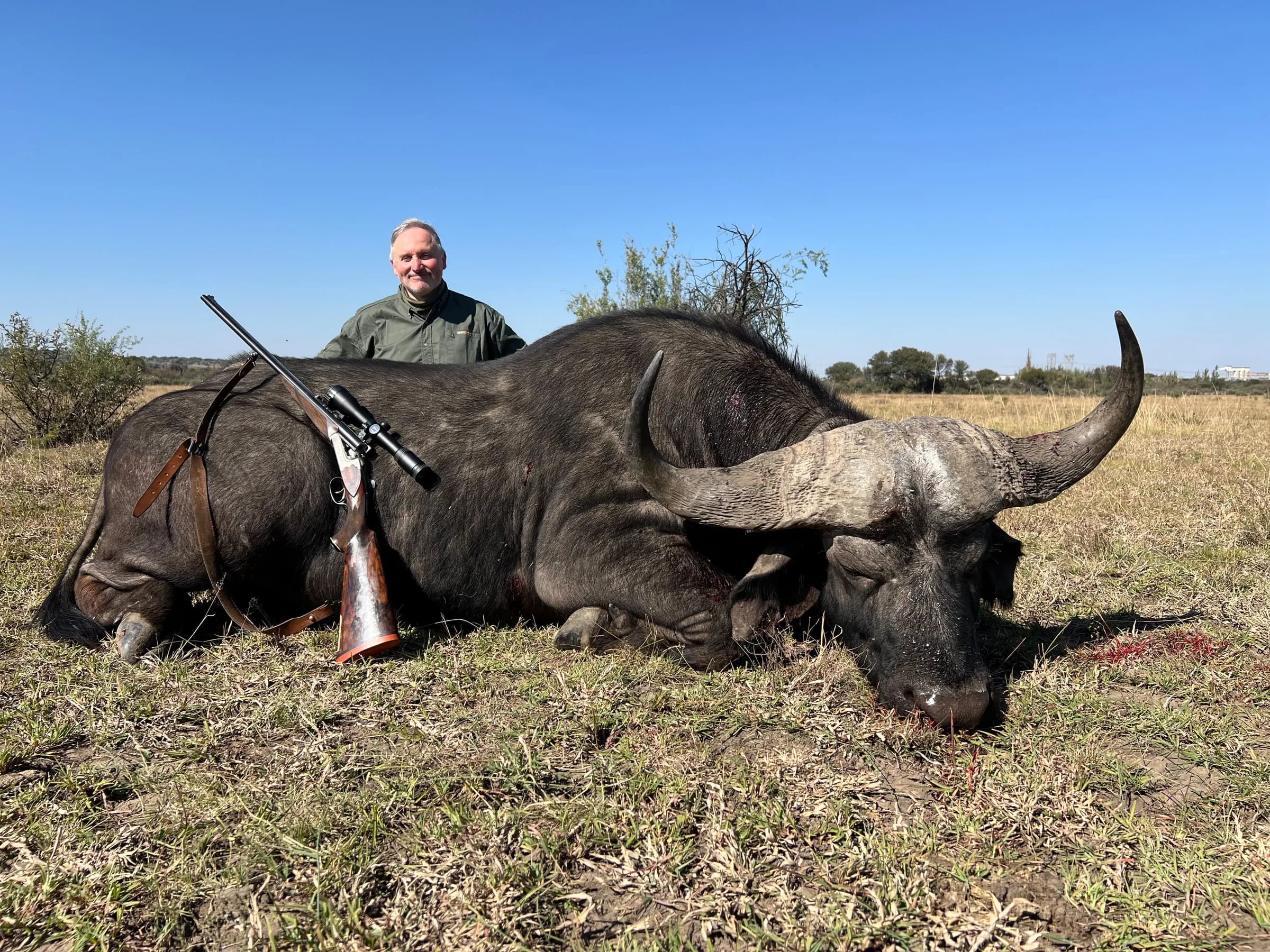A hunter with a blue wildebeest bull